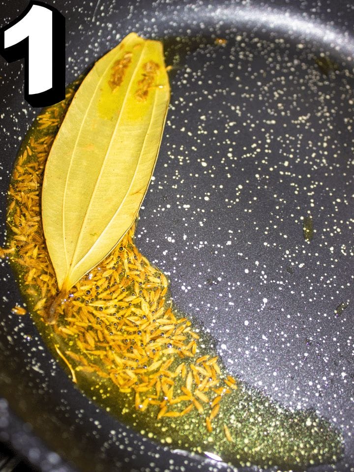 ADD OIL AND ADD CUMIN SEEDS, BAY LEAF.