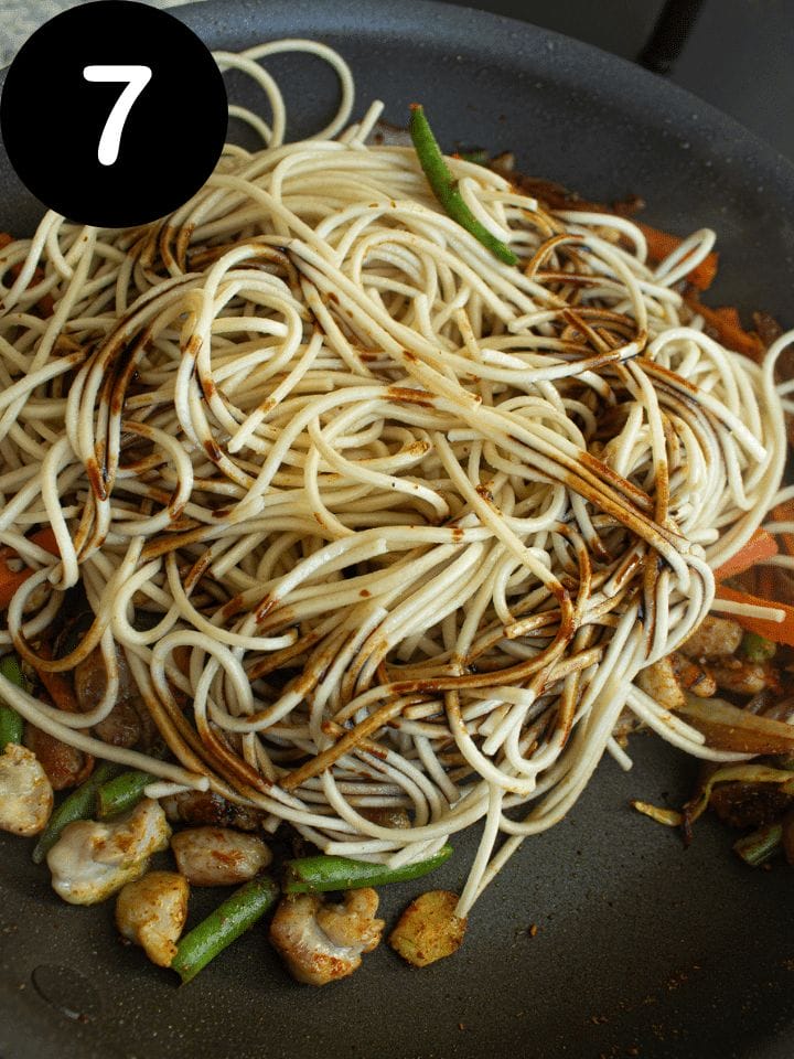 ADD SOY SAUCE AND NOODLES